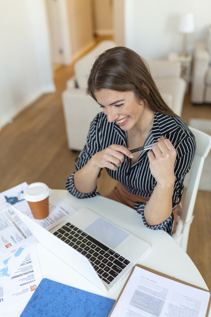 business woman analyzing data using computer while spending time in the office. beautiful young grinning professional woman in office. graphs and charts